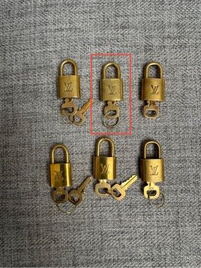 #330 Louis Vuitton Gold-Tone LV Padlock Key Charm